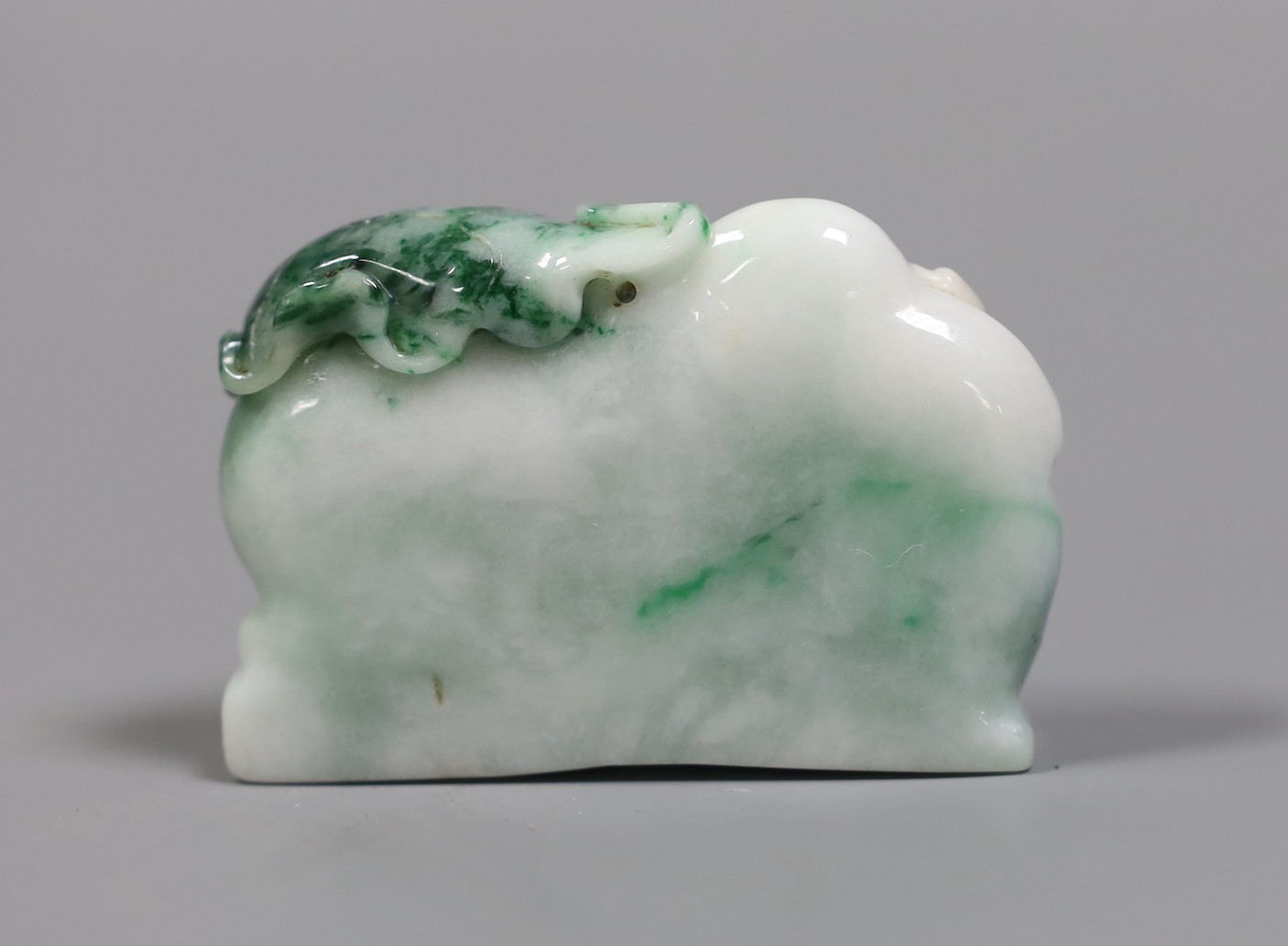 A Chinese jadeite Budai reclining figure, 6 cms wide